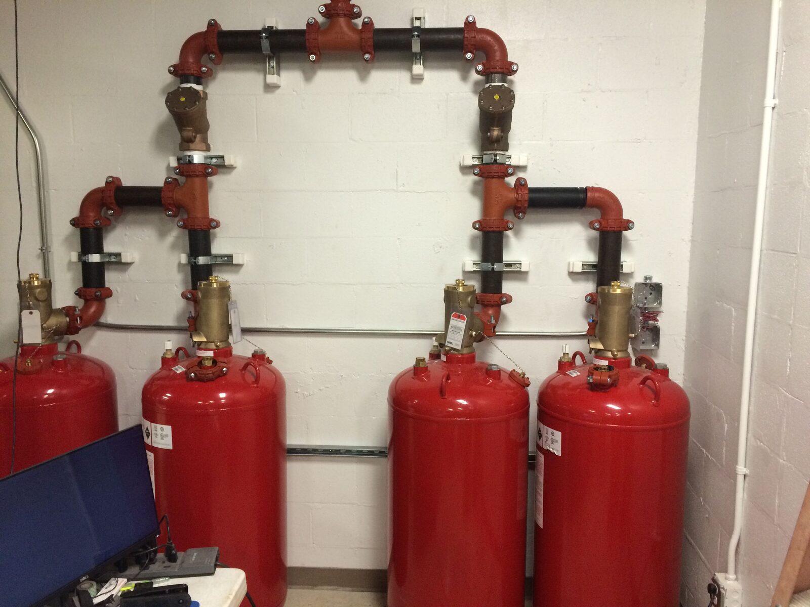 Piped clean agent suppression cylinders